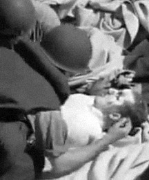 Unidentified sailor looks after kamikaze victim